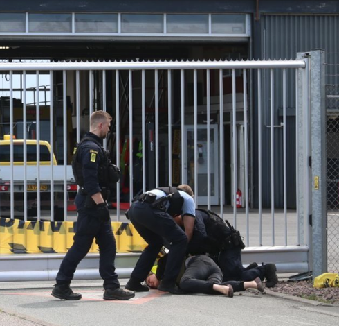 Assoc. Prof. Laura Horn being pinned down by police.