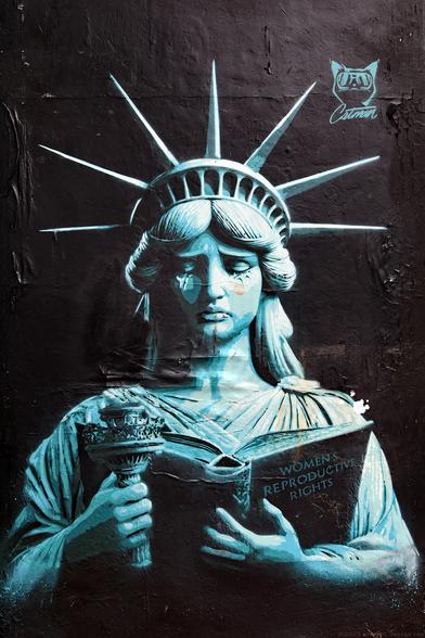 Photo of stencilled artwork by Catman depicting Lady Liberty and the decline of women's reproductive rights in the USA. Bond Street, City of Brighton & Hove, UK