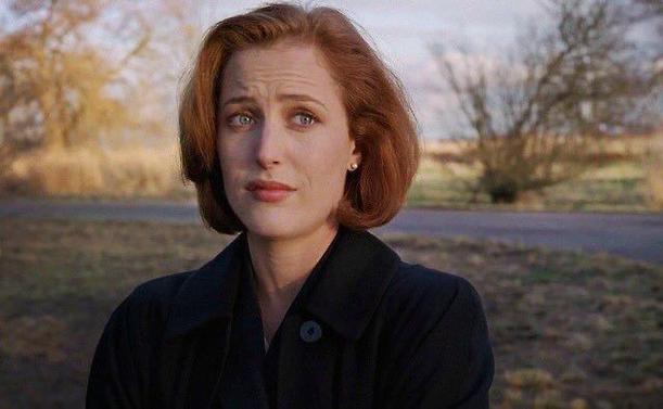 Scully with "done with your shit" facial expression. Looking to the side.