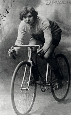 studio postcard of Alfonsina Strada on her bike. She is a white woman with dark hair.