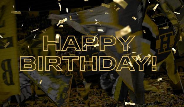 Football fans waving flags with gold leaflets dropping from the sky and the words HAPPY BIRTHDAY overlaid.