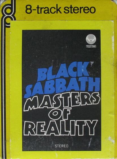 A photo of a vintage 8-track cartridge tape by Black Sabbath entitled "Masters of Reality" in a yellow outer box. Band name is printed in a large flowing blue font across the middle; the album title is printed in white outlined letters beneath. The Vertigo swirl record label is at the top right, and "stereo" is printed at the bottom, all on a black background.  Text printed at the top of the yellow box reads "8-track stereo".