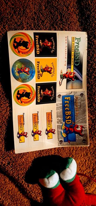 The photograph composed in absolute darkness shows a sheet of stickers laid out on a brown carpet. The stickers are related to freeBSD, a free and open-source operating system. The stickers feature a cartoon character resembling a red devil with antlers, wearing blue shoes and holding a pitchfork. The text "Powered by FreeBSD" is prominently displayed on several stickers, along with the website "www.freebsd.org." The stickers come in various designs, including circular logos with a colorful background and a silhouette of the character, rectangular labels with the character in different poses, and a larger sticker with the character on a blue background. The sheet also includes a larger sticker with the text "FreeBSD" and "The Power to Serve" on a gray background. The overall theme of the stickers is playful and colorful, with a focus on promoting the freeBSD operating system.

 Ovis2-8B

🌱 Energy used: 0.205 Wh