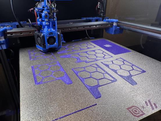 Purple Voron 2.4 skirts being printed on a Voron Trident 3d printer. The first layer is just about complete.