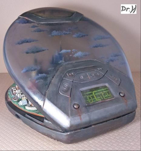 Rear view of the CD city. The clouds painted on the clear lid of the player were first painted in reverse; darker details first then working up to the lighter full shape of the cloud. And then on the inside, the clouds were painted as normal so that they are visible from both sides.