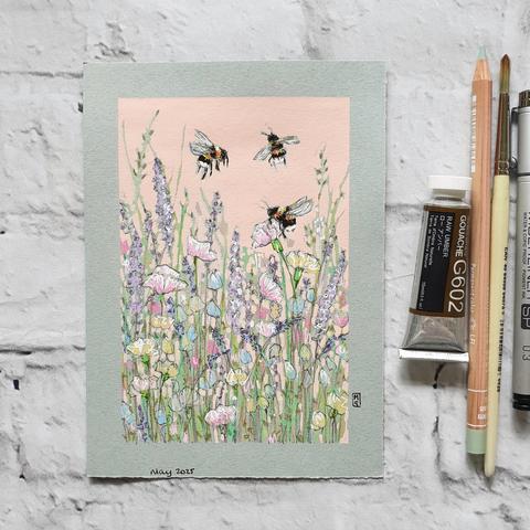 A small artwork of three bees buzzing over a mixed bed of pastel toned flowers. The drawing has a pink background and is on grey pastel paper.
An original art work
Colour pencil and mixed media on acid free toned artist paper
5 by 7 inches (12.7 by 17.8 cm).
Sold unframed