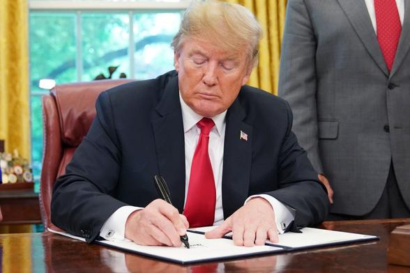 President Trump finishing his picture prompt in response to a picture of what looked like sand with a car parked in it. It earned him a 100% for English class.