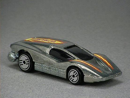 Released in 1985, Unpainted Silver Bullet of 1985 Hot Wheels with Ultra Hot wheels. Notes: Concept model. Tampo: Yellow, orange and purple lightning on top with 'Ultra Hots' in back. Packaging: 1985 Blister. Metal Body, Metal Base. Made in Hong Kong. Scarcity: 2/10