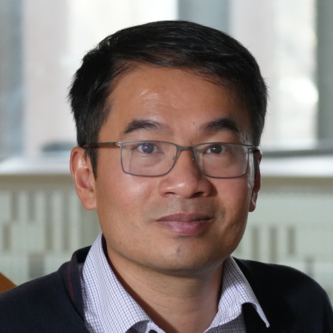 Picture of Minh Bui wearing glasses and a business shirt with a collar