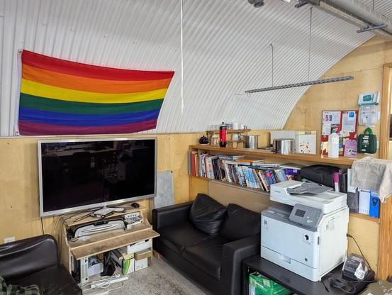 Rainbow flag hung on a workshop wall