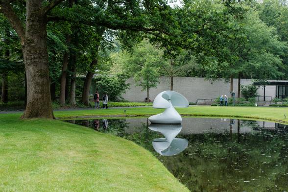 A white sculpture reflected in a pond at Sculpture Flotantte 'Otterlo', Netherlands.