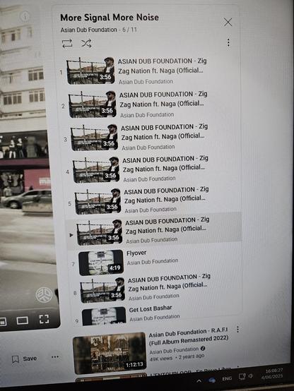 a phone picture of a monitor. the monitor shows the youtube playlist. it repeats zig zag nation 6 times. then a different song, then zig zag nation once more. then other songs.