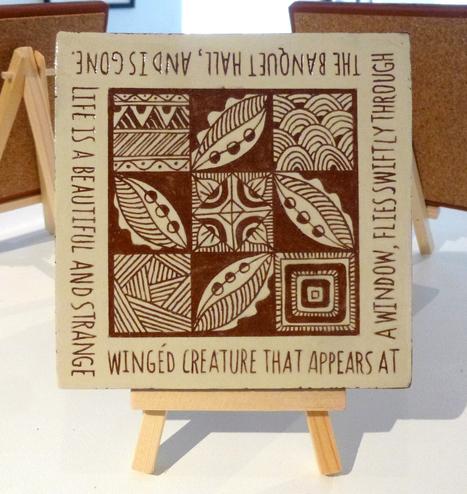 Handmade sgraffito tile decorated with abstract patterns and a quotation by the Venerable Bede about the transitory nature of life.