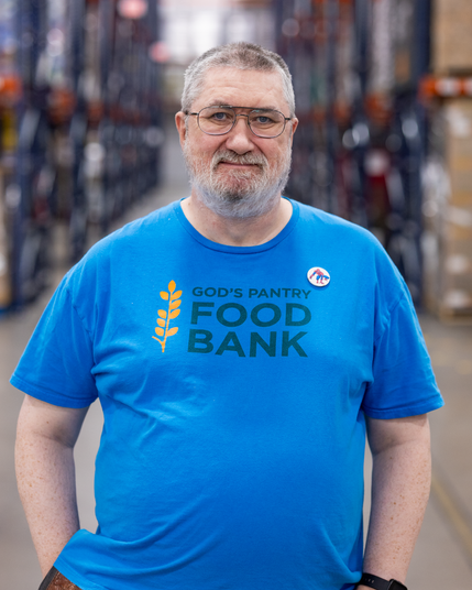 Official headshot of Peter Paterson for God's Pantry Food Bank.
I am wearing a blue shirt with the work logo, and a Spider-Man badge.