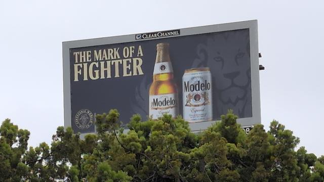 A billboard for beer with the slogan "The Mark of a Fighter"