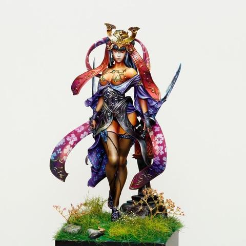 This is a breathtakingly intricate miniature figure that fuses artistry, elegance, and a sense of otherworldly mystique. The figure is dressed in a complex mix of garments and armor. Her armor is a dark metallic shade, ornately sculpted with flowing patterns that intertwine like vines, complementing the fantastical theme. Delicate, cherry-blossom-like designs adorn her flowing purple garments, which billow dramatically around her figure, suggesting movement despite the static nature of the miniature. Her stance is commanding yet poised, suggesting confidence and a sense of purpose, as if she is about to step into a legendary battle or an elaborate narrative.