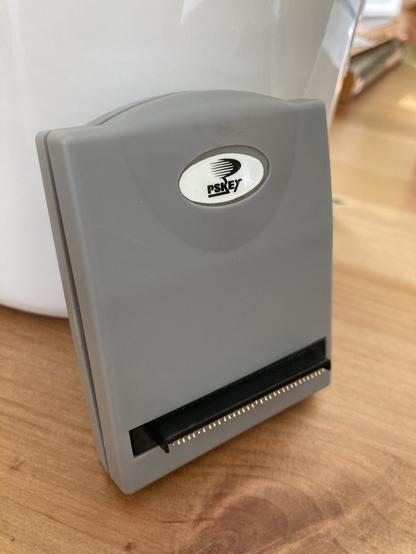 A small grey box with a "PSKey" logo at the top.

At the bottom are two rows of opposing pins which attach to the I/O port of a playstation 1.
