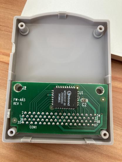 The internal printed circuit board of the pskey. It is just a pin connector soldered in at the bottom, and a Winbond EEPROM chip at the top.