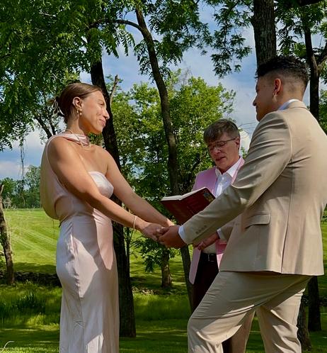 Me giving the vows to the happy couple. Observant readers will note the Tintin book to hold my notes. The theme was pink, and it's what I had on hand.