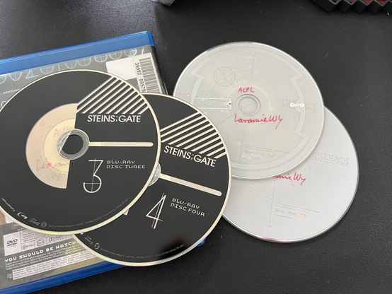 The contents of the Blu-ray Steins;Gate The Complete Series set I checked out from my library (via loan from another state library), consisting of DVD disc 3, DVD disc 4, Blu-ray disc 3, and Blu-ray disc 4.