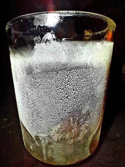 Ice condensing on a frozen glass tumbler with subzero Mümmelman resembles an ice moon.