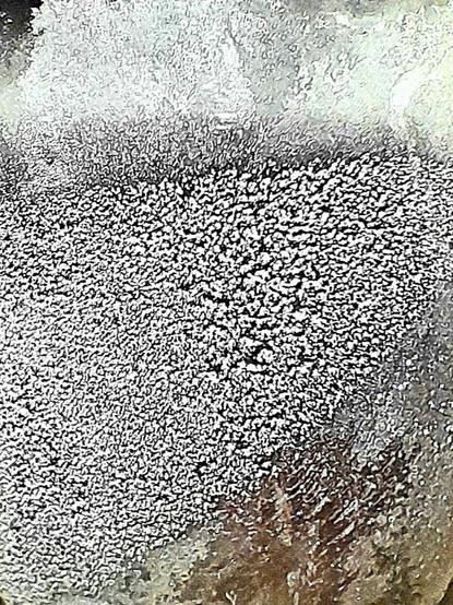 Ice condensing on a frozen glass tumbler with subzero Mümmelman resembles an ice moon.