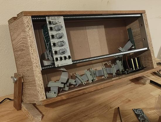 Wooden Eurorack case with Tiptop rails (84hp), MFOS power supply, flying bus cable, and one module installed - Doepfer A-110-1 VCO