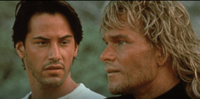 keanu reeves and patrick swayze regard each other in an image from Point Break