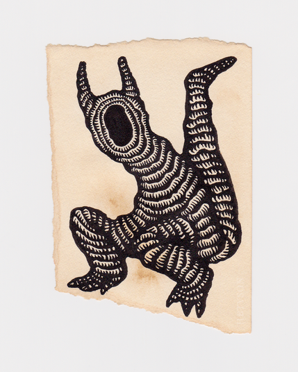 A scrap paper stained with coffee that has a drawing of a bipedal creature. It has a blank hole for a face, horns and a thick tail. The creature is constructed from a rope or tube-like material.