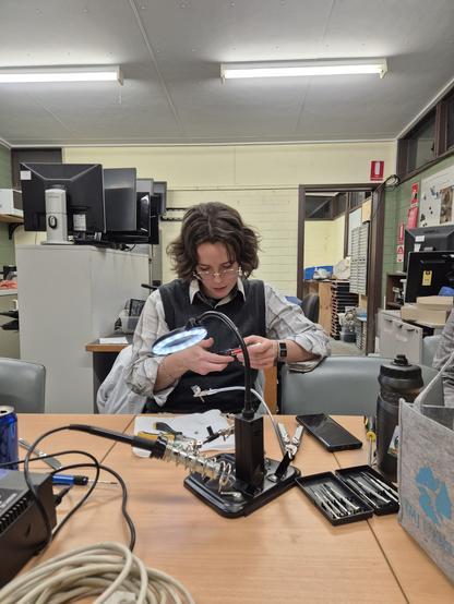 Person examining a broken electric toothbrush in attempt to repair it