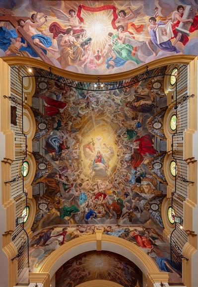 Ceiling of the Oratory of Saint Mary Queen and Mother, Málaga, Spain. The church was constructed in 2008 and is host of the Confraternity of the Sorrows. The paintings in the ceiling, done with acrylic paint, are work of Raúl Berzosa Fernández and were executed in different phases between 2008 and 2014. The 140 square metres (1,500 sq ft) surface is dedicated to the Coronation of the Virgin.
