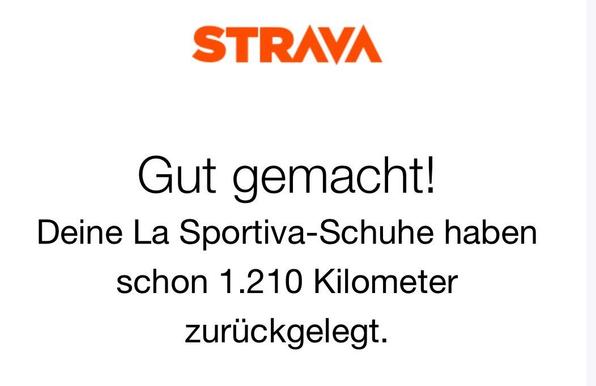 An image featuring the Strava logo at the top. Below is a message in German that congratulates the user, stating that their La Sportiva shoes have covered 1,210 kilometers.