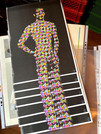 several prints of a person standing in front of a black background. The persons skin is covered by a color pattern that is used to imitate neutral gray in Prints. The pattern is vastly enlarged. seven Prints are lying in a slightly stacked position. Like this it seems that the person has extremely long legs