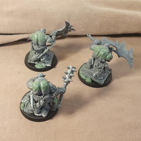 The backs of the same pirate orruks, showing sculpted back muscles and assorted loot / baggage