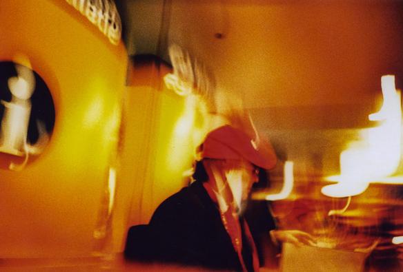 A long exposure blurred candid shot of a man sitting in some bar - possibly Madrid. Taken on 35mm Agfa CT Precisa xproed slide film using a Lomography Lc-a camera.