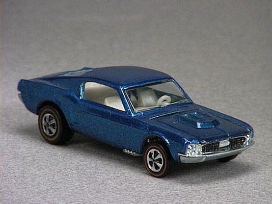 Released in 1968, Spectraflame Aqua Custom Mustang of 1968 Hot Wheels with Redline wheels. Notes: US casting has small steering wheel, raised dashboard, black in center portion of the taillights, fuel tank cap is outlined, front grill has vertical bars and painted black. Packaging: 1968 Blister. Metal Body, Metal Base. Made in USA. Scarcity: 7/10