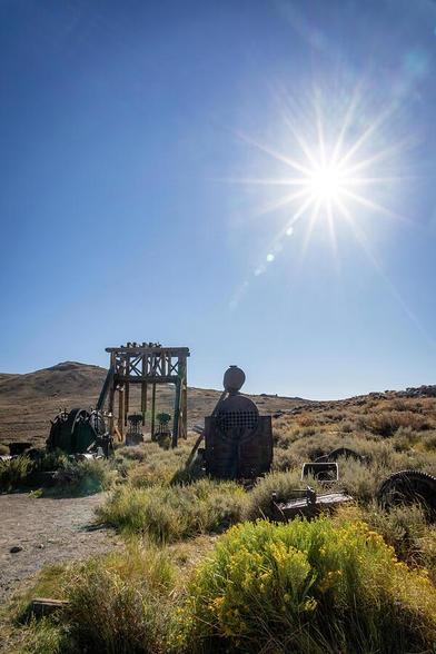 Abandoned mining equipment rests under a bright sun in Bodie State Historical Park, California, offering a glimpse into the 19th-century gold mining history of this preserved ghost town.