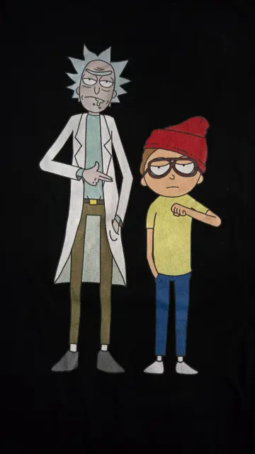 The image features two animated characters on a black background. On the left is a character with spiky gray hair, wearing a white lab coat over a light blue shirt, brown pants, and gray shoes. He has a serious expression and is pointing with his right hand. On the right is a younger character with brown hair, wearing a red beanie, glasses, a yellow shirt, blue jeans, and white shoes. He has a neutral expression and is pointing with his left hand. Both characters are standing side by side, with the older character slightly taller. The image appears to be a graphic design, possibly for a t-shirt.