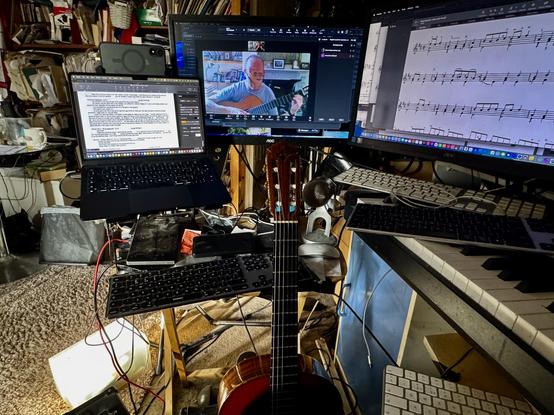 A view of my online teaching setup at home, with one screen for the Zoom session, another one with the music we are working on and finally a laptop screen where I take notes of the lesson which I email to the pupil.