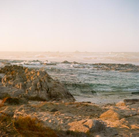the rocky ocean shore at golden hour