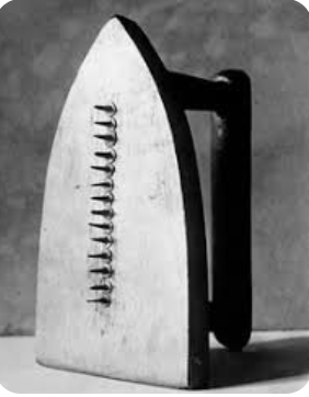 iron standing up with nails in a line coming out of the center.