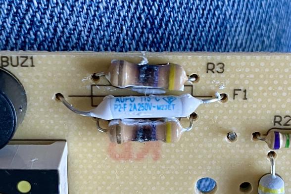Before, showing burned resistors and blown thermal fuse.
