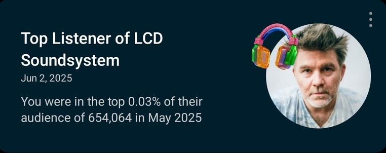 The image features a dark blue background with white text and a circular image on the right side. The text reads "Top Listener of LCD Soundsystem" followed by the date "Jun 2, 2025." Below this, it states, "You were in the top 0.03% of their audience of 654,064 in May 2025." On the right side, there is a circular image of a person wearing a light-colored shirt, with colorful headphones superimposed on the top of their head. The headphones are vibrant, with pink, green, and orange colors.