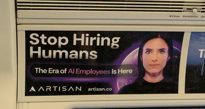 Photo of a London tube train ad showing an AI-generated female face in front of an earth-like purple-lit planet. Text reads "Stop Hiring Humans
The Era of *AI Employees* Is Here
Artisan - artisan.co"

Asterisks denote purple highlighted text (the rest is white)