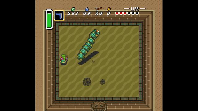 The scene is set in a sandy desert landscape within the game The Legend of Zelda: A Link to the Past. In the foreground, two main characters can be seen: Link is standing and appears to be interacting with the environment, while a green creature resembling a worm or snake slithers along the ground nearby. The desert scene has rough-textured sand covering the ground and sparse vegetation visible in the background. There are no UI elements present that provide additional context within this screenshot. The perspective is first-person, suggesting that the player character is Link.