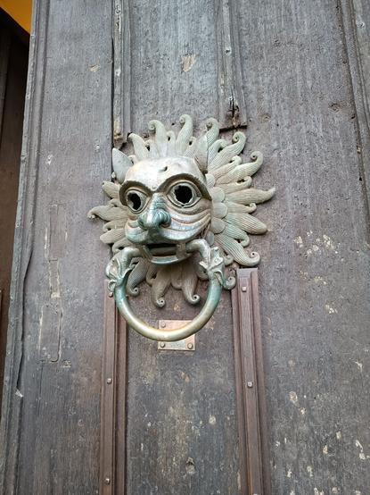 A close-up of the door knocker. Called a 'hellmouth' it is said to represent a lion devouring a man (?) The ring, which was grasped by the supplicant,  is fashioned as a snake.
