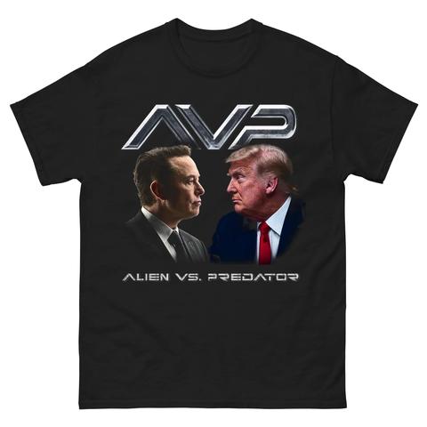A black t-shirt featuring an illustration of Elon Musk and Trump facing each other, with the text "AVP" at the top and "ALIEN VS. PREDATOR" at the bottom. The design parodies the movie title, combining elements associated with