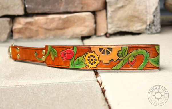 A photo of just the leash, which has the same flowering vines and gears motif as the collar