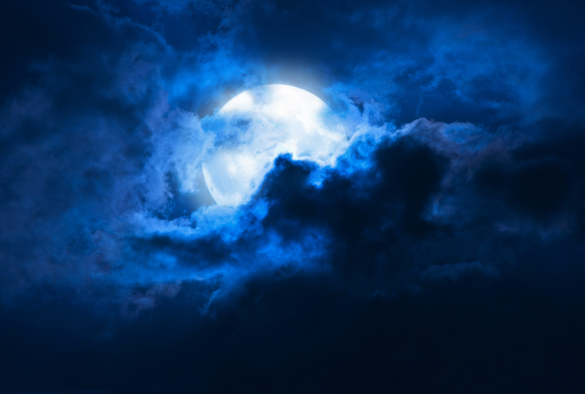 Full moon peering out of clould cover.