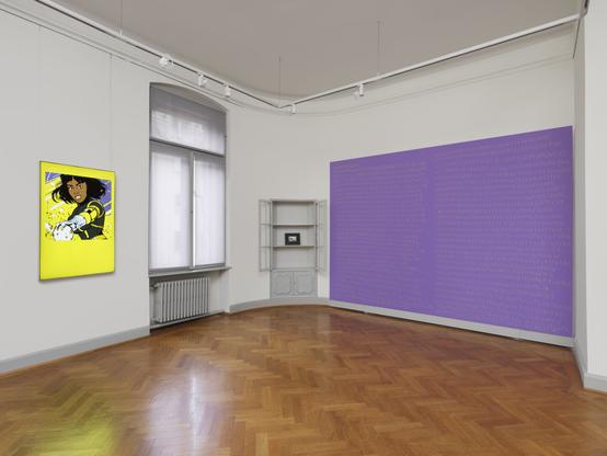 We see the corner of a room in which a grey display cabinet is built into the wall. Both hinged doors are wide open. There is only one picture frame in the cabinet. To the left of the cabinet hangs a light box with a picture of a comic book superheroine and to the right of the cabinet is a purple-coloured wooden panel that has been mounted on the wall. There are yellow numbers and letters on the wall. The floor of the room is covered with parquet and there is a window between the light box and the display cabinet.